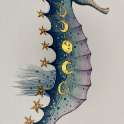 close up of hand embellished gold details on moonphase seahorse