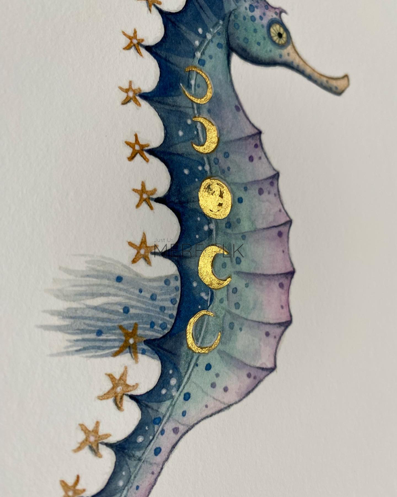 close up of hand embellished gold details on moonphase seahorse